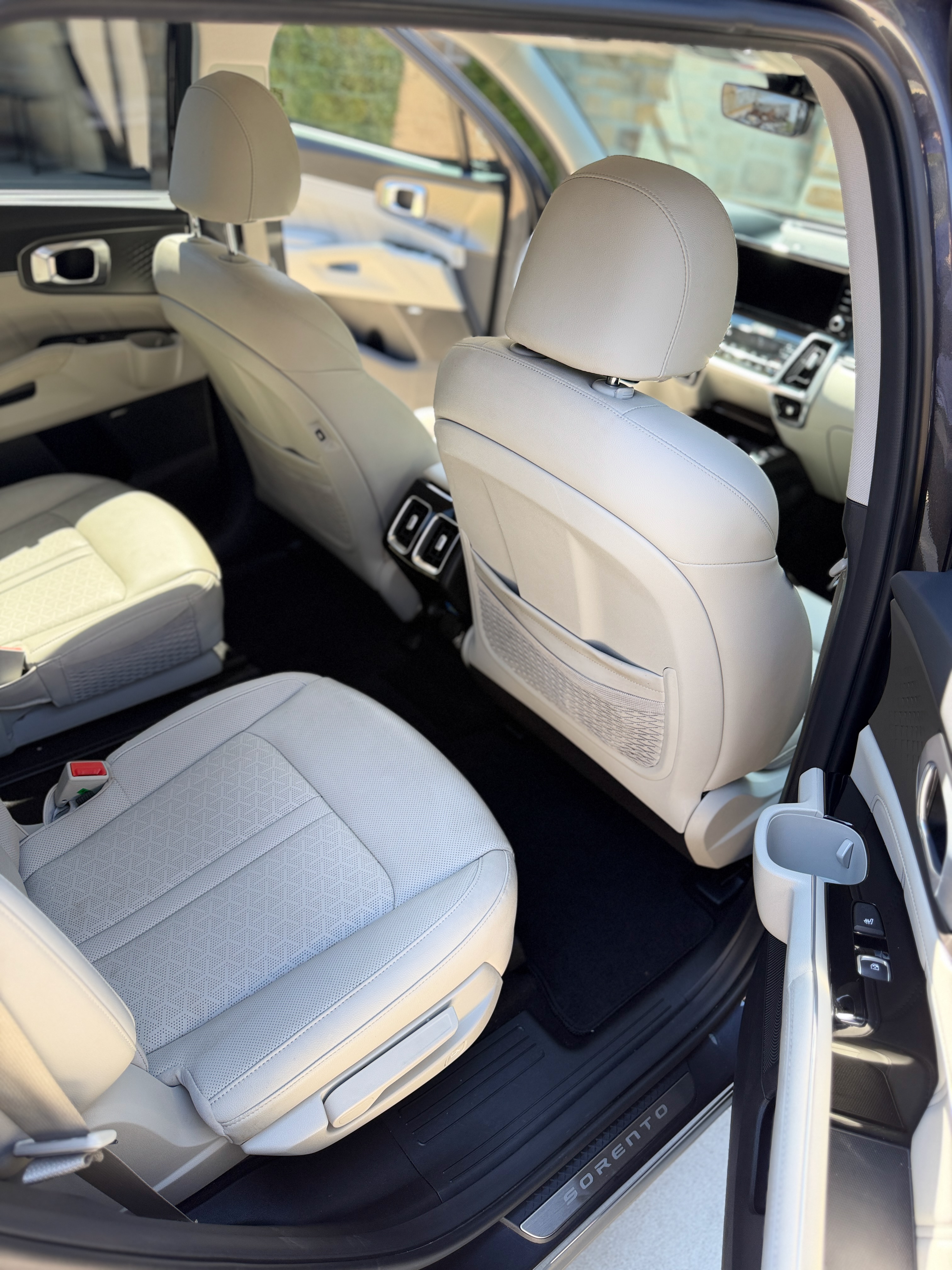 Kia Sorento 3-row interior detail after mobile car detailing in Edgerton Kansas — white leather seats cleaned and conditioned by Premier Detailing LLC