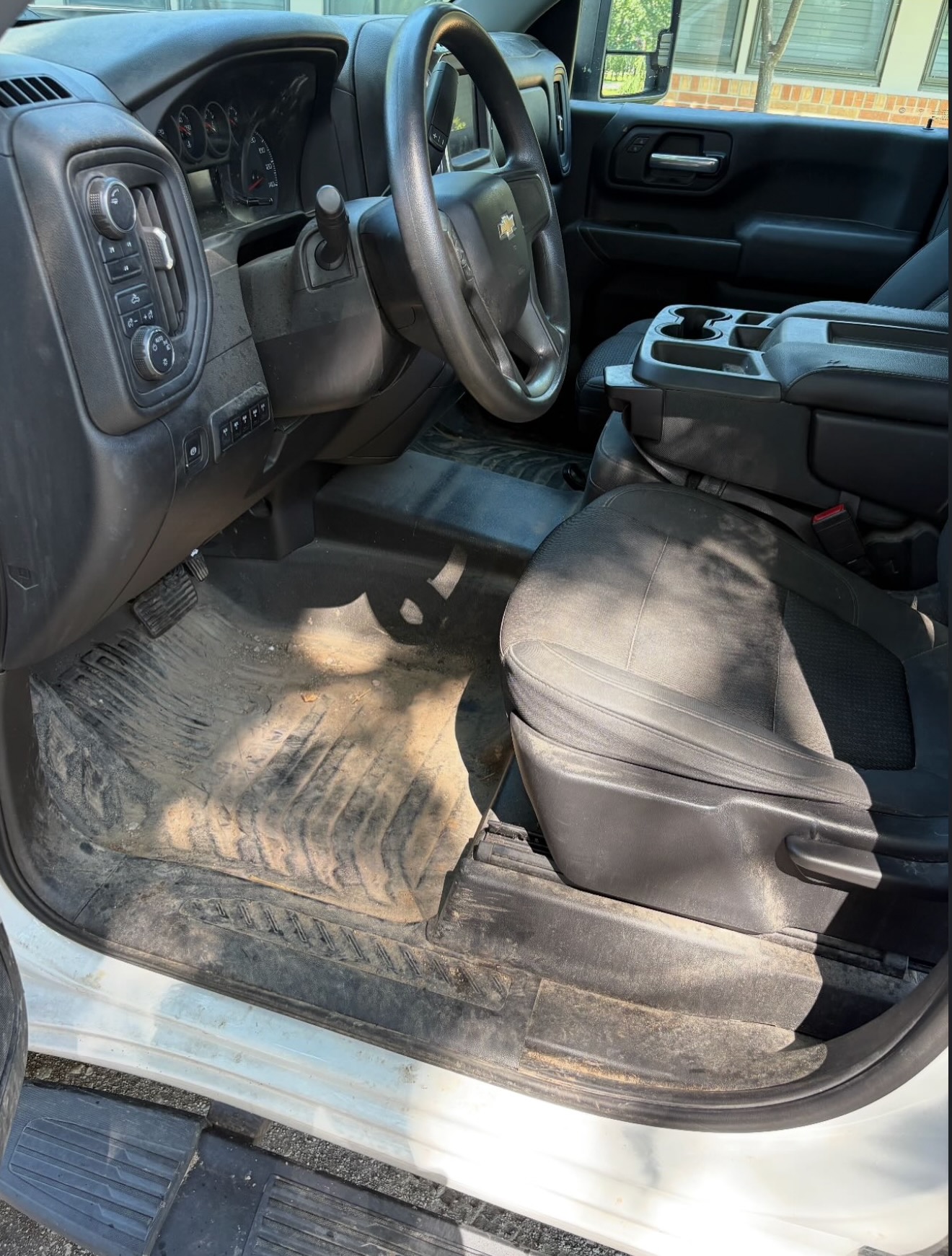 Chevy Silverado truck interior before detail — construction dirt and grime