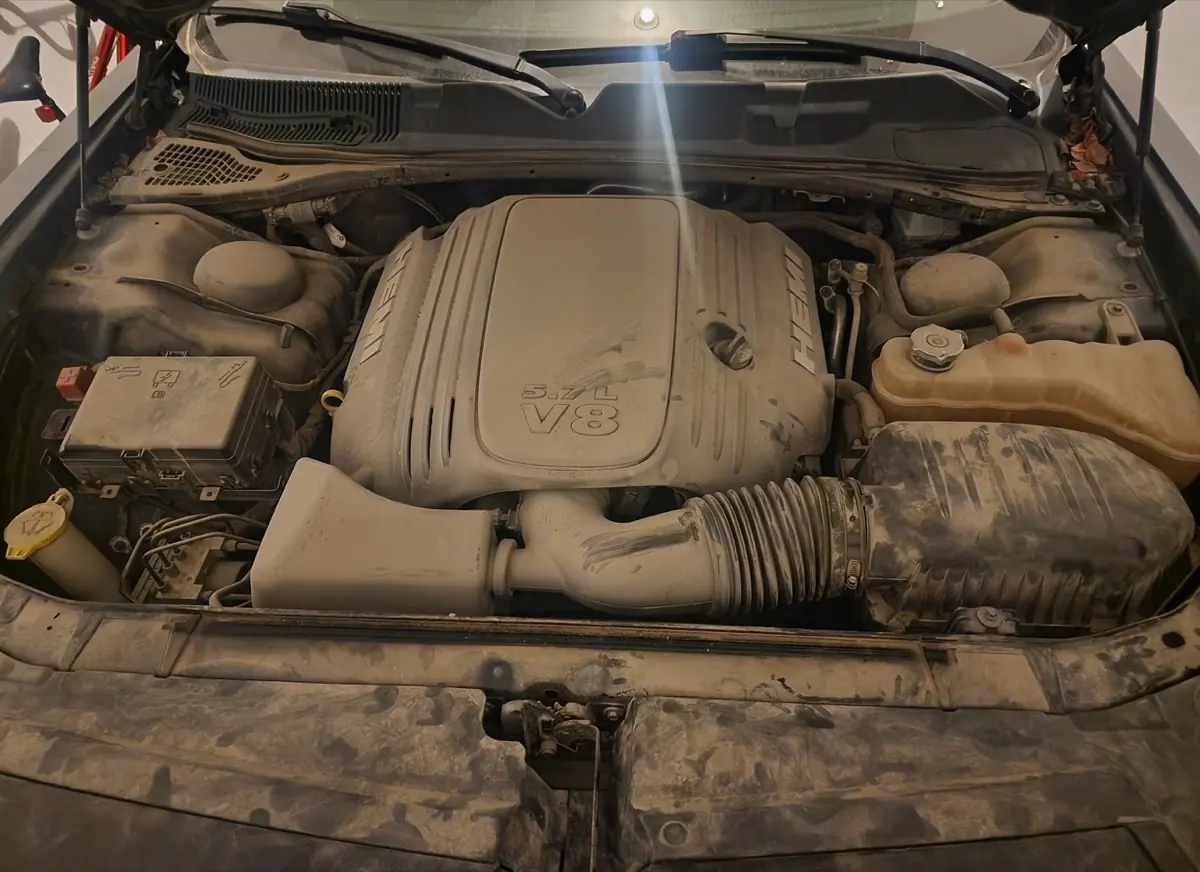 Dodge HEMI 5.7L V8 engine bay before detail, heavy dust and dirt on plastics and hoses,Premier Detailing LLC Johnson County Kansas
