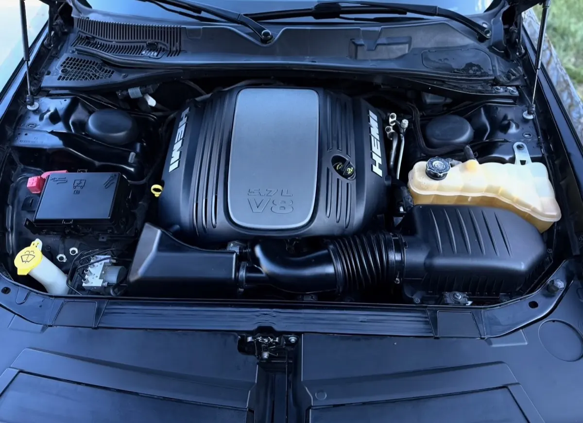 Dodge HEMI 5.7L V8 engine bay after professional detail, glossy black plastics and dressed components,Premier Detailing LLC mobile service Johnson County Kansas