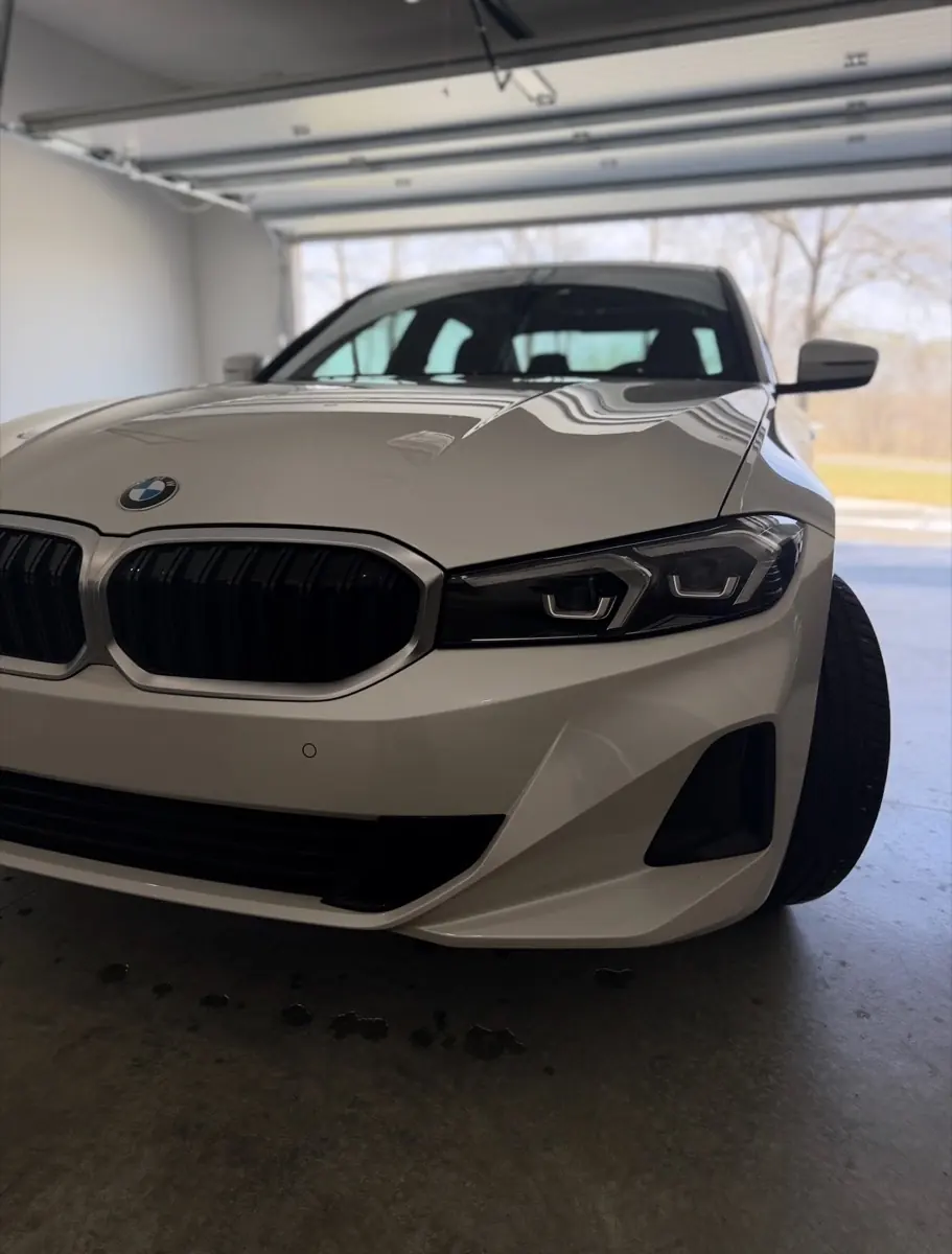White BMW 3-series exterior after mobile detail, glossy finish parked in garage,Premier Detailing LLC mobile car detailing Johnson County KS