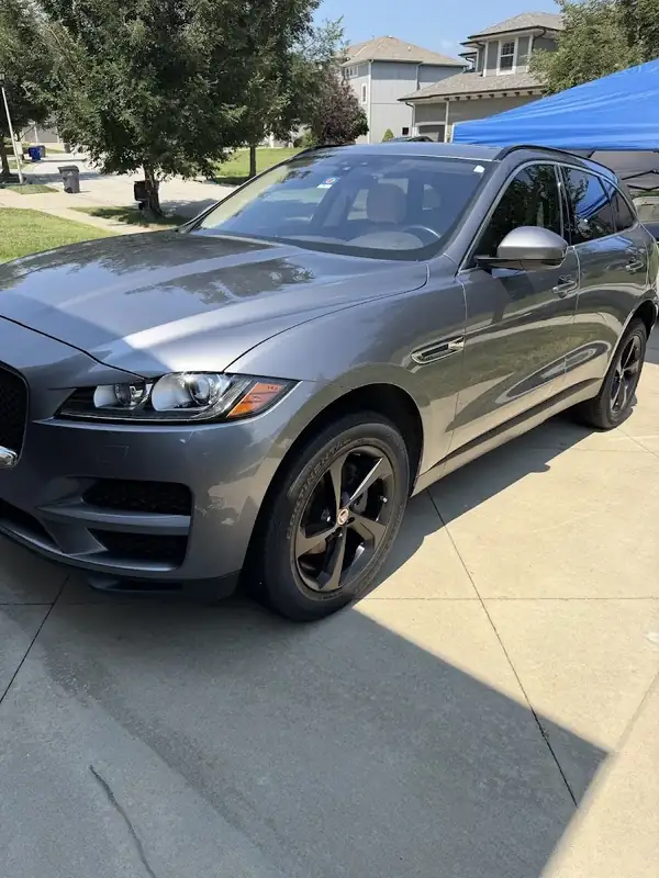 Gray Jaguar F-Pace in a Lenexa driveway after a mobile detail