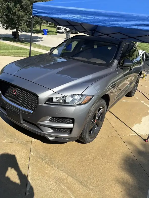 Gray Jaguar F-Pace front end after washing under a canopy in Lenexa