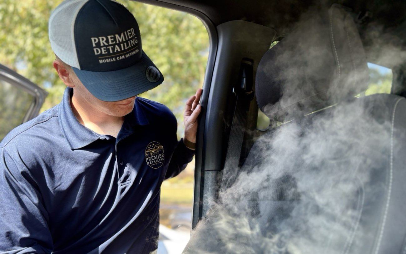 Joe Young, owner of Premier Detailing, steam cleaning a truck interior in Johnson County, Kansas